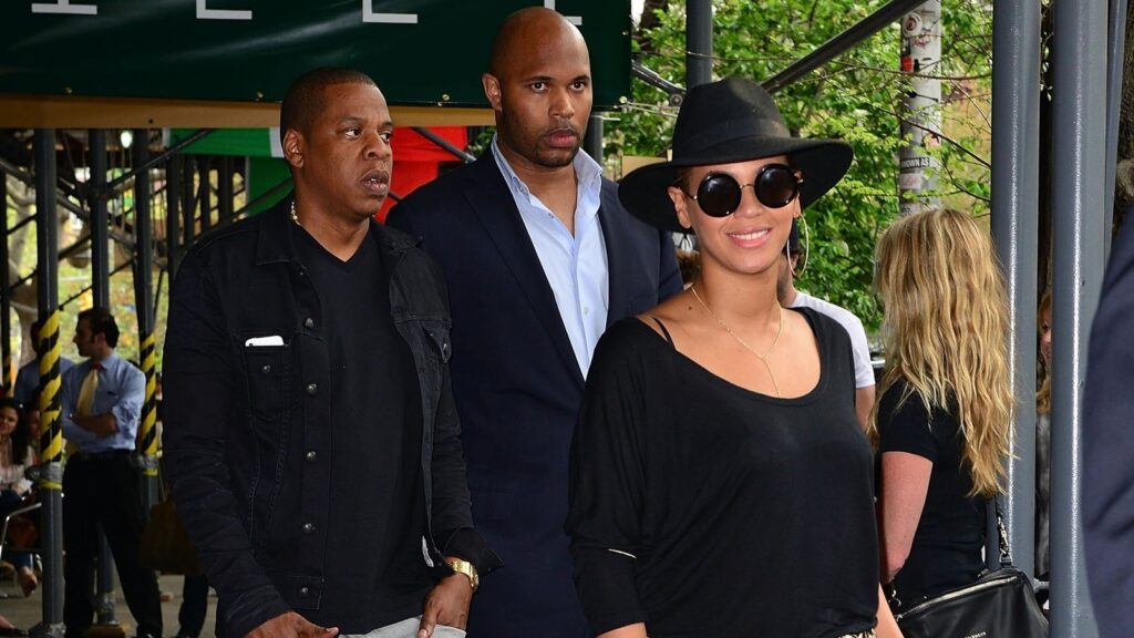 Beyonce’s stoic bodyguard cracks a rare smile during her Grammy moment & it’s got fans swooning; ‘fanfic writes itself’