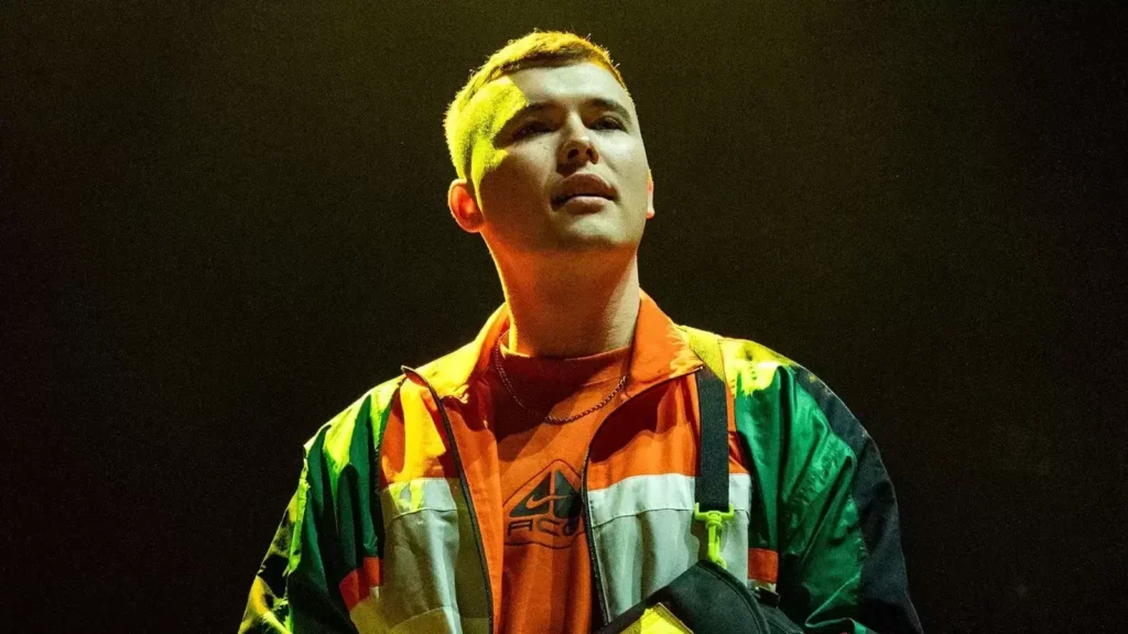 Kneecap’s surprise London concert a day after terror charge sells out in 90 seconds, Mo Chara arrives with tape on mouth