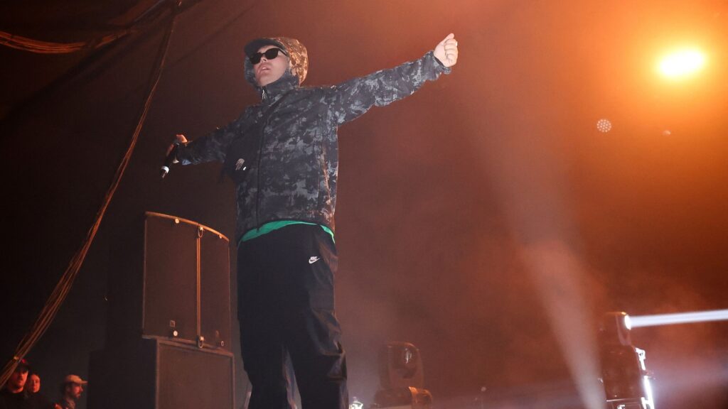 Who is Liam O’Hanna aka Mo Chara? Irish rapper from Kneecap charged with terror offence for act at London concert